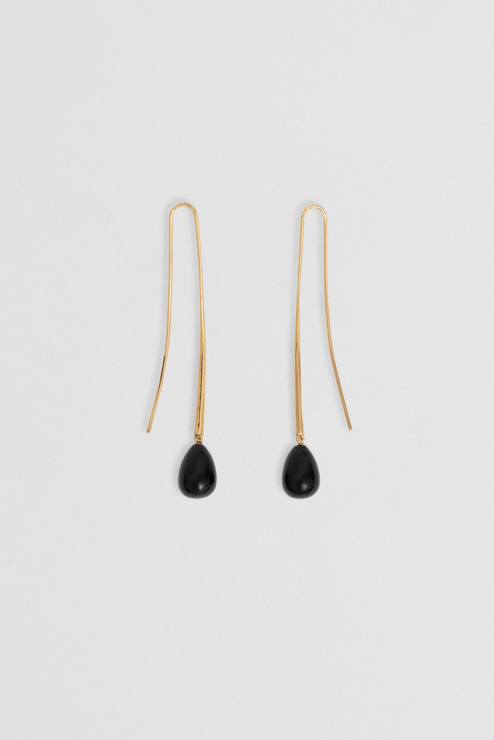 Close up veiw Black onyx earrings in 14k vermeil, long tear drop design.