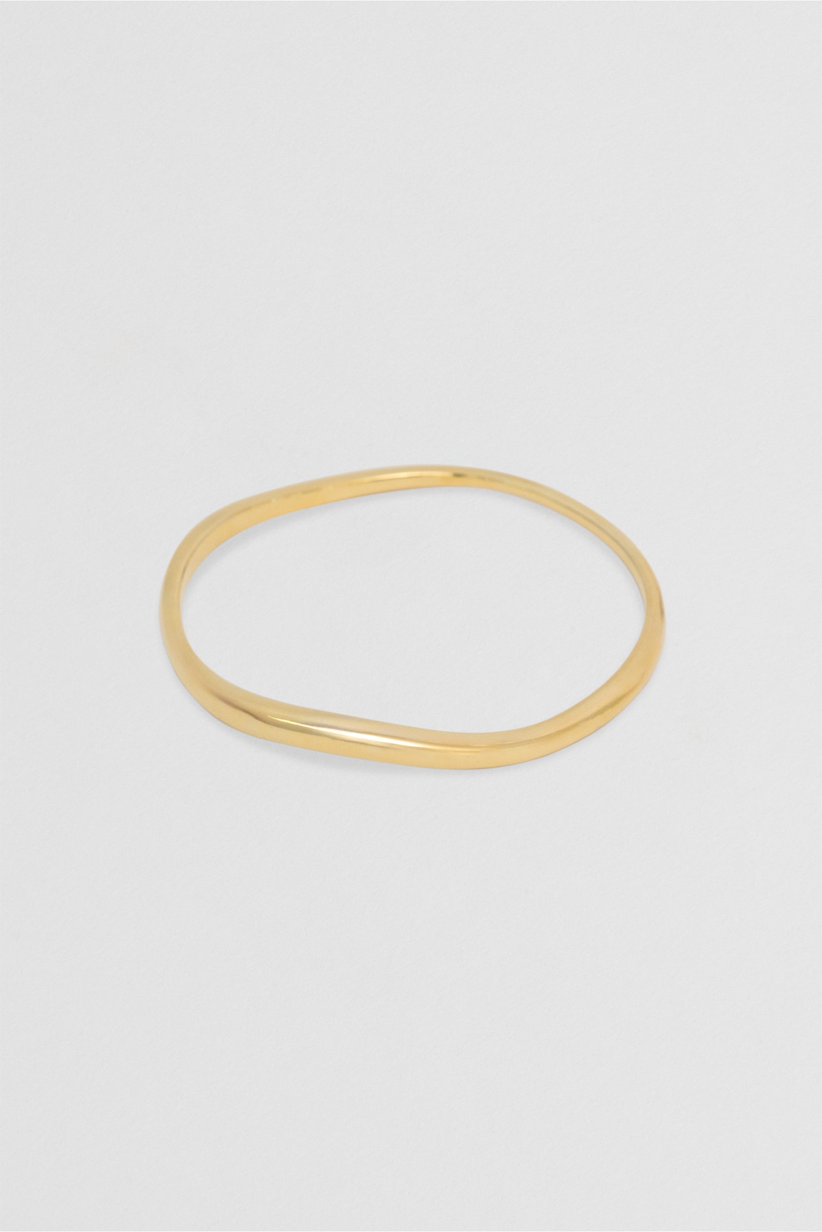 Close up Fundamental Bangle 14k Vermeil: Organic-shaped bracelet in recycled gold.