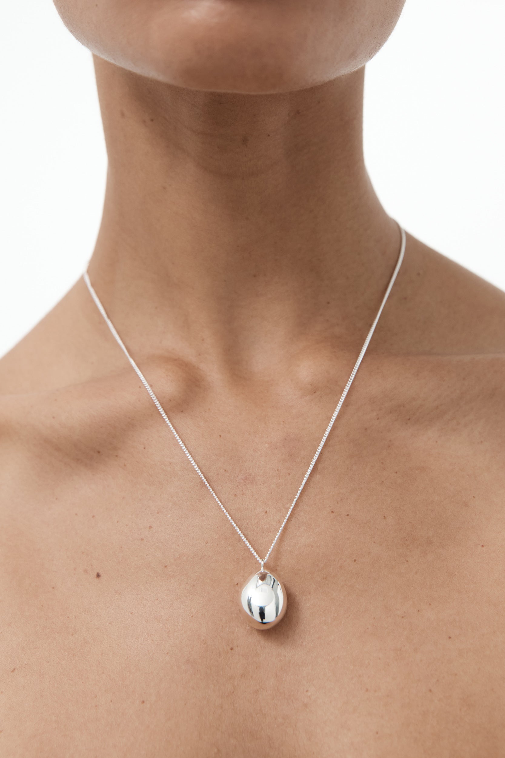 Silver drop necklace with a pendant on an adjustable fine chain, featuring a parrot clasp, made from recycled sterling silver.