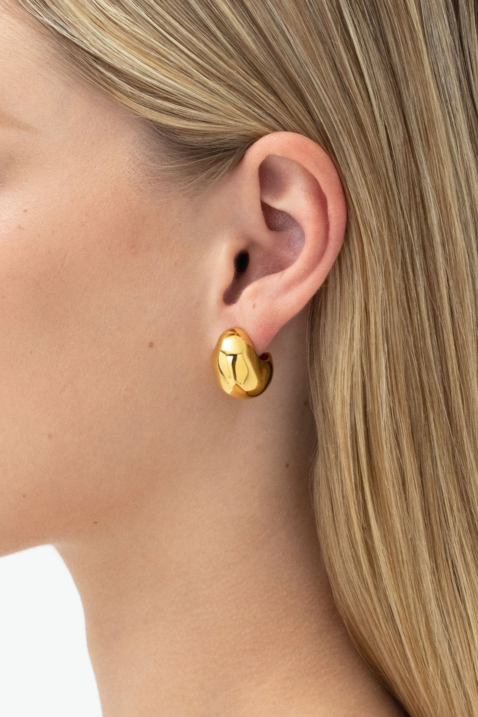 Side profile of model with Figure Hoops Gold, 20mm Dome Hoop earrings