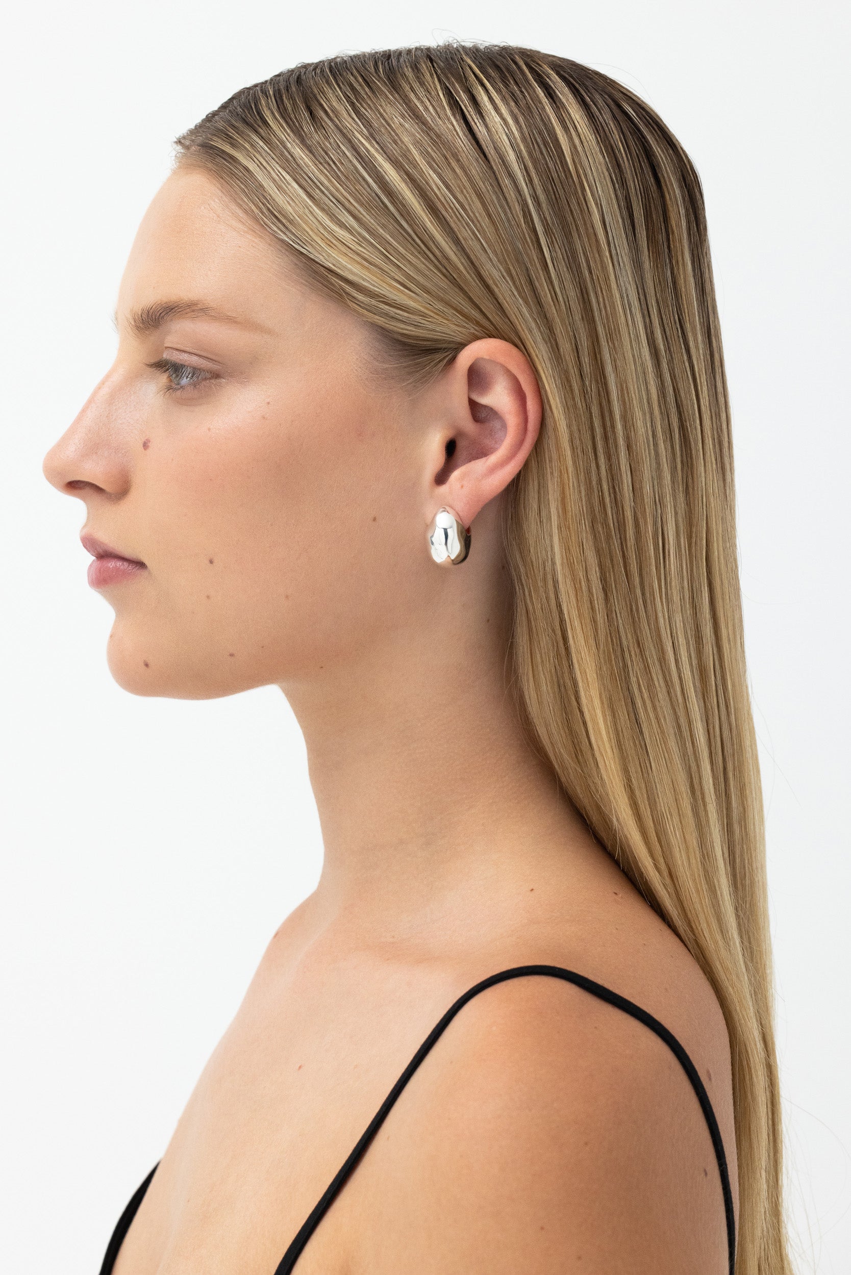 Model wearing Figure Hoops Silver, 20mm dome hoops with stud back, recycled sterling silver