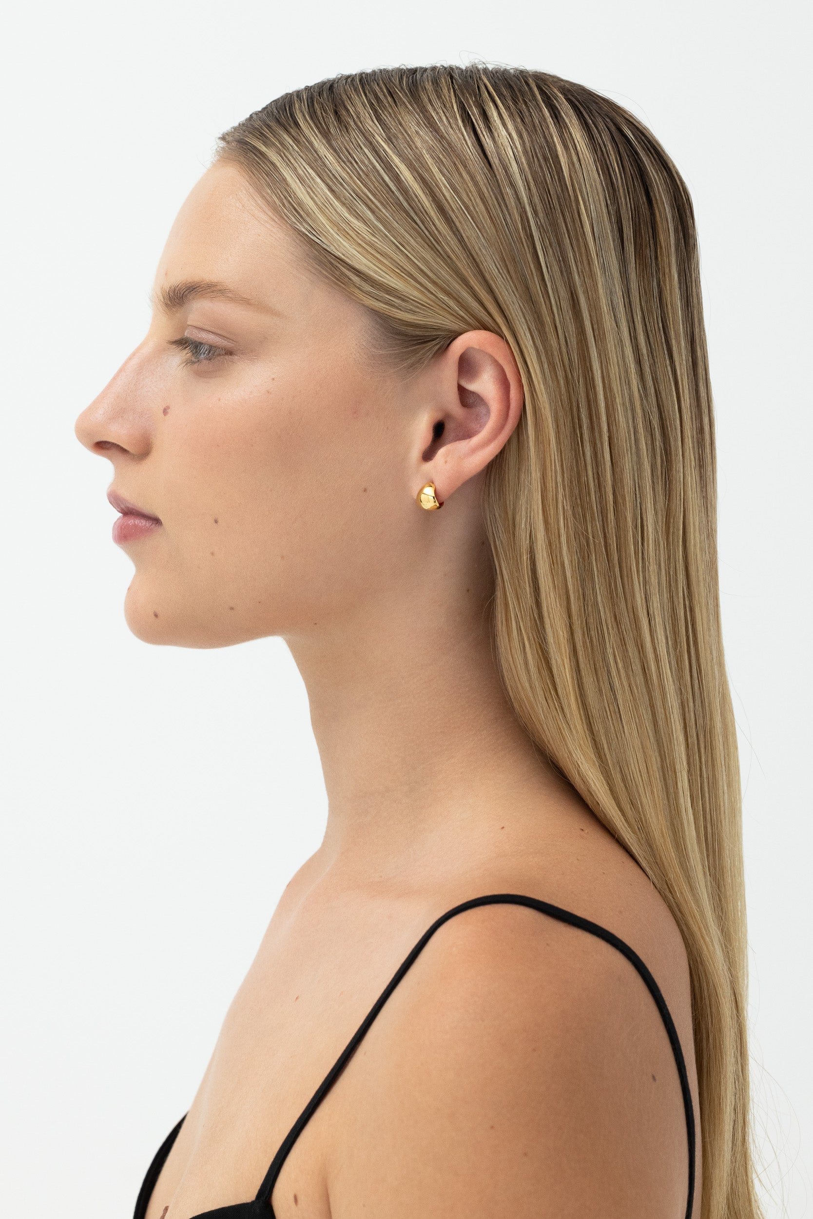 Small Gold Fold Hoops: Chic, minimalist hoops for versatile styling, on model