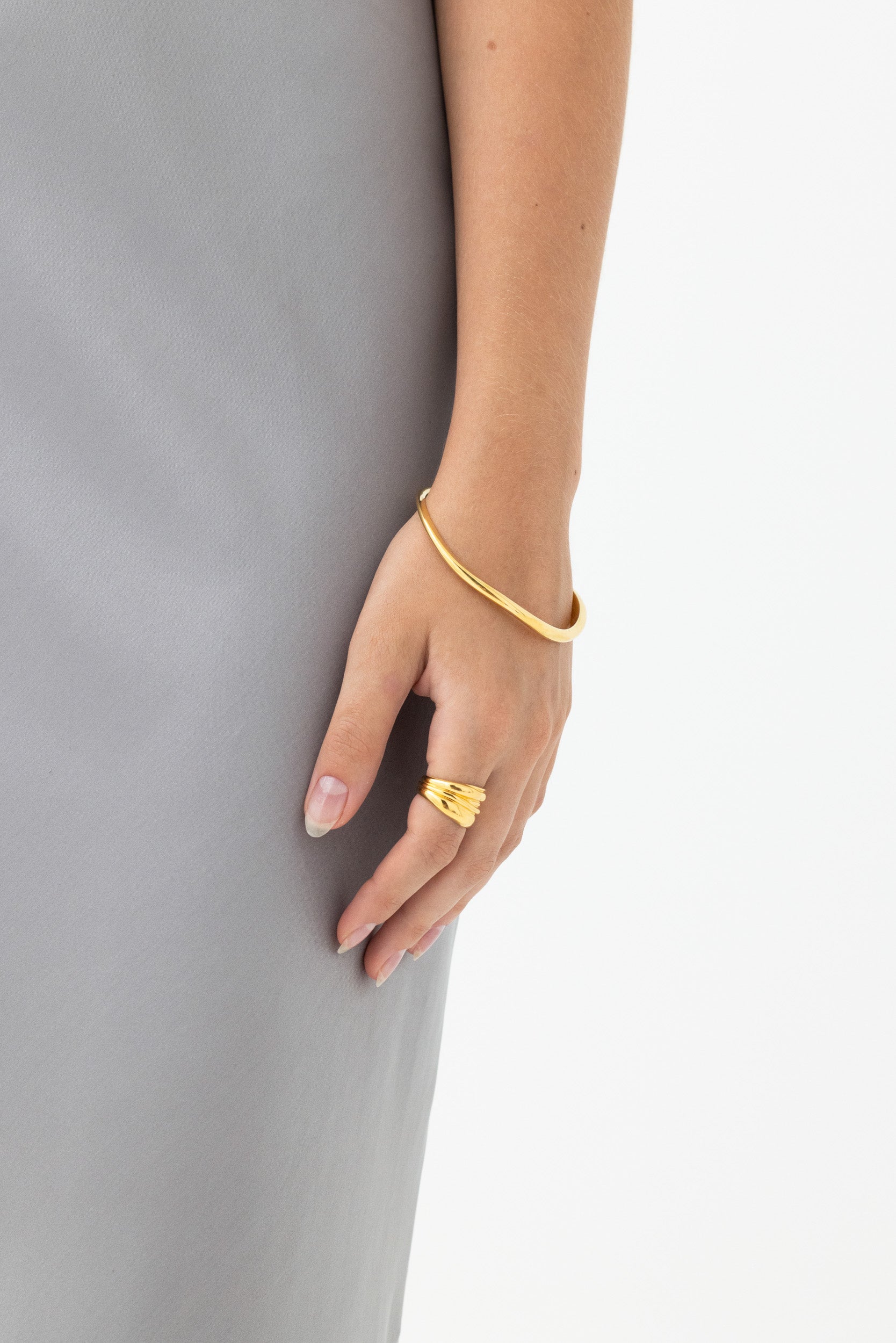 Model wearing Fundamental Bangle 14k Vermeil: Organic-shaped bracelet in recycled gold.